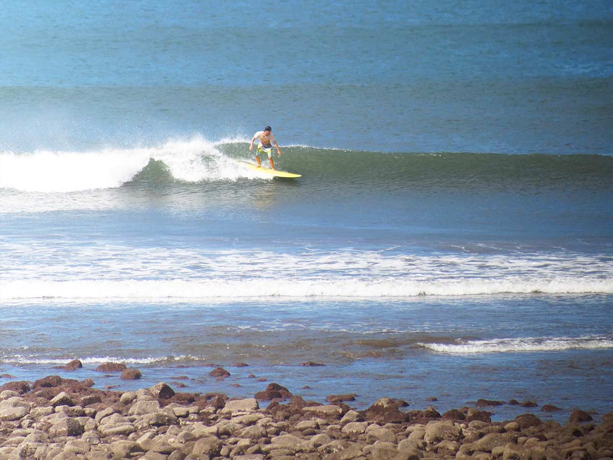 a man surfing a left point break