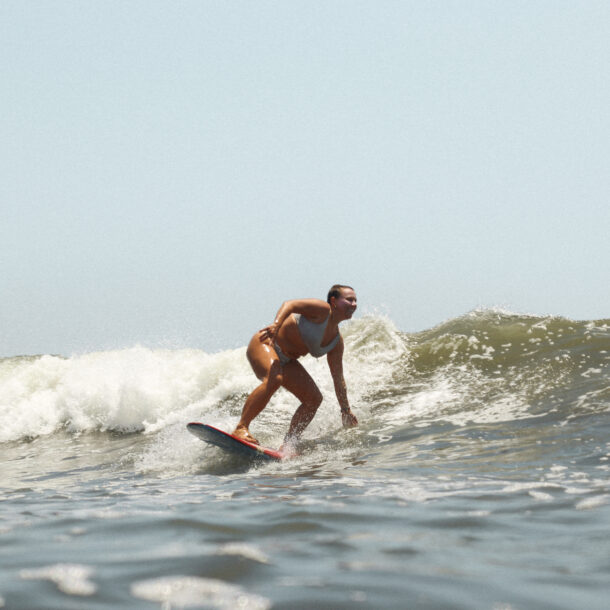 a girl having fun surfing on a sunny day