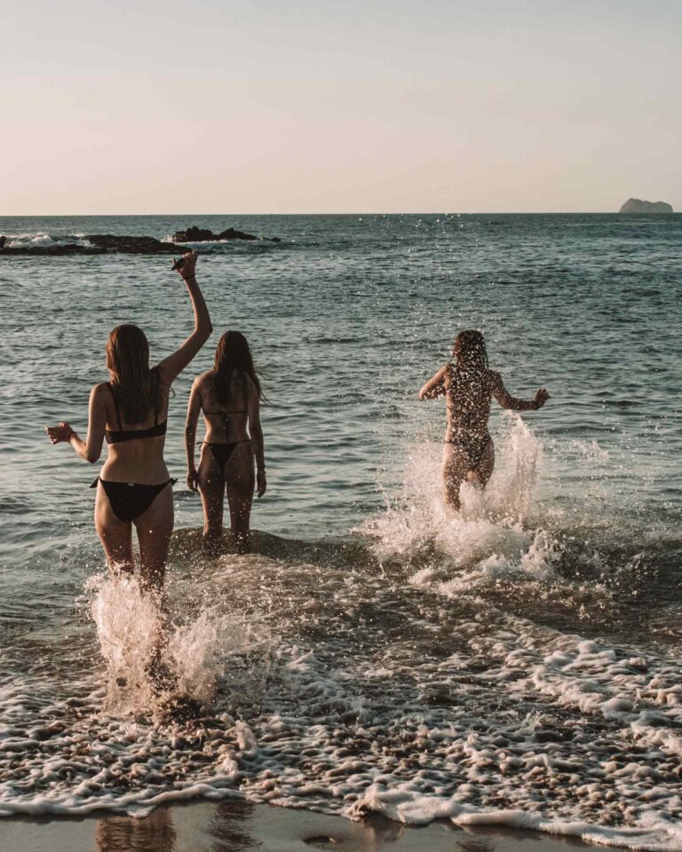 girls having fun running into the ocean. Sunny Rebels Surf & Yoga Retreat